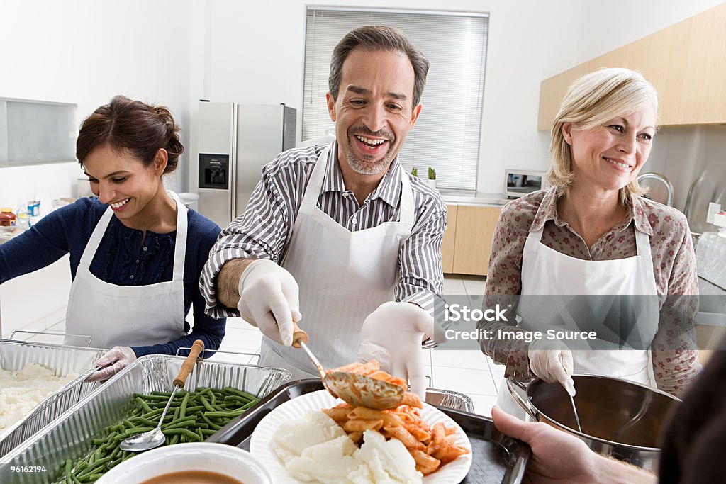 Volunteers delivering soup at a kitchen